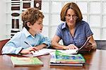 Woman helping her grandson in homework