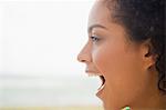 Close-up of a woman shouting on the beach