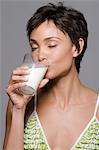 Close-up of a woman drinking milk from a glass