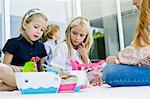 Three girls playing with toys