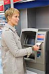 Woman receiving a transaction slip from an ATM