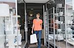 Woman coming out of a store after shopping