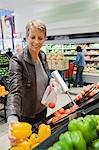 Woman buying vegetables in a supermarket