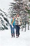 Young couple embracing, walking in snow