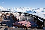 Restaurant terrace surrounded by snow covered mountains