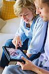 Man and a little boy looking at digital tablet