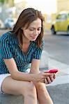 Young woman text messaging with a mobile phone