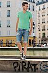 Man standing on the ledge of a canal, Canal St Martin, Paris, Ile-de-France, France