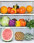 Bright fruit and vegetables are on the shelves in the refrigerator.