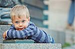 Smiling three year old cute boy clouse-up portrait on town background