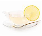 Glass cup of tea with lemon on white background