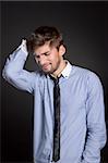 Young business man headache over gray background