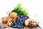 Fresh blueberries with muffins and ingredients, rustic style