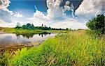 Summer panoramic landscape with river and church