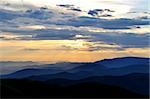 Cloudy sunset over emerald Carpathian mountain ridges