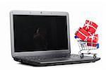 red gift boxes in shopping cart on a laptop, cut out from white