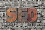 seo - search engine optimization - text in vintage wood letterpress printing blocks against grunge metal typeset