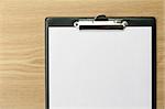 Clipboard with blank paper on office table