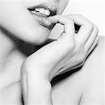 Black and white fashion abstract portrait of beautiful woman with tenderness finger and lips