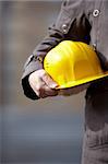 man with yellow hardhat , selective focus on hand