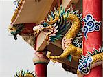 Right Golden dragon statue on red pillar in Chinese Temple style