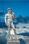 Statue of David on blue sky with white clouds. Copy of original        in Florence, Italy