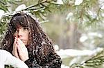 portrait closeup young girl praying on the background of the winter forest