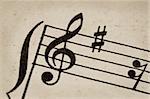 treble clef - macro of sheet music on vintage paper