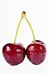 Close up view of pair of cherries isolated over white background
