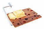 Wooden cutting board with pieces of cheese on a white background.