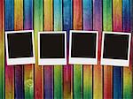 four blank photos on colorful wooden background