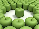 Green apple of the cubic form in an environment of usual green apples.