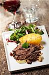 sliced sirloin steak on a plate with salad