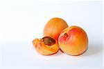 three fresh juicy ripe apricot with white background