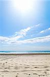 empty beach at sunny day with footprints, Spain