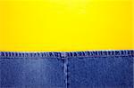 Blue jeans with yellow stitches and yellow background