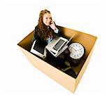 Businesswoman in a very small Cardboard Office isolated on white background