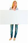 Full length portrait of teen girl holding blank billboard