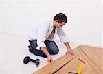 Home improvement - worker installing laminate flooring