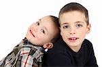 Two young brothers against a white background