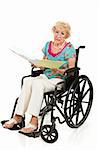 Senior woman in wheelchair holding a stack of bills.  Full body isolated on white.