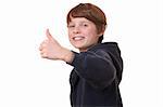 Portrait of a teenage boy with thumbs up on white background