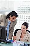 Portrait of a smiling business team making a market research in an office