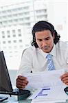 Portrait of a businessman looking at statistics in his office