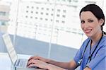 Doctor using a notebook in her office