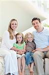 Family sitting on the couch together