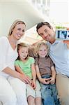 Man taking family picture on the couch