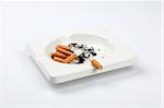 ashtray full of cigarettes on white