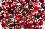 Red ripe cherries laid on white table