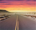 Lonely desert highway in rural Arizona at sunset